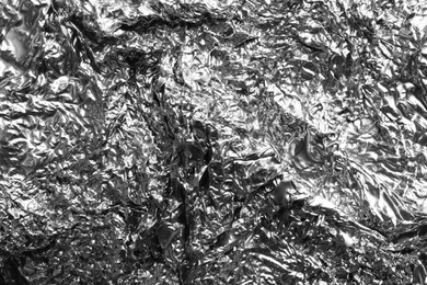 Crumpled silver foil as background, closeup view