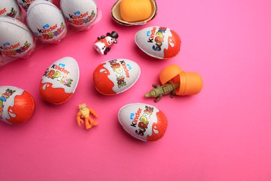 Photo of Sveti Vlas, Bulgaria - June 26, 2023: Kinder Surprise Eggs, plastic containers and toys on pink background, flat lay