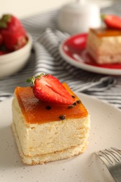 Photo of Piece of cheesecake with strawberry on plate, closeup