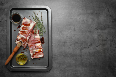 Photo of Fresh raw ribs on grey table, top view. Space for text