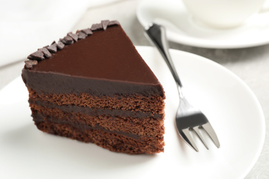 Photo of Piece of tasty chocolate cake served on plate