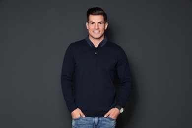Photo of Portrait of handsome man smiling on grey background