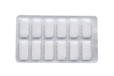 Photo of Blister with chewing gums on white background, top view