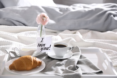 Photo of Romantic breakfast with note saying I Love You on bed