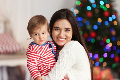 Photo of Mother and her cute baby at home. Christmas celebration