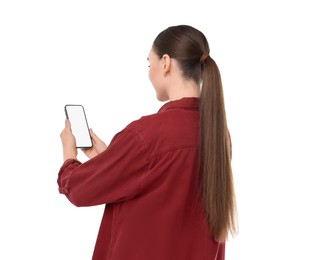 Photo of Woman holding smartphone with blank screen on white background, back view