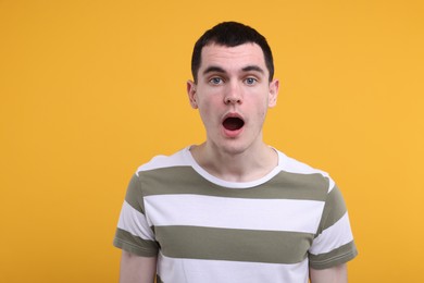 Photo of Portrait of surprised man on orange background