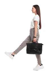 Photo of Beautiful businesswoman with briefcase walking on white background