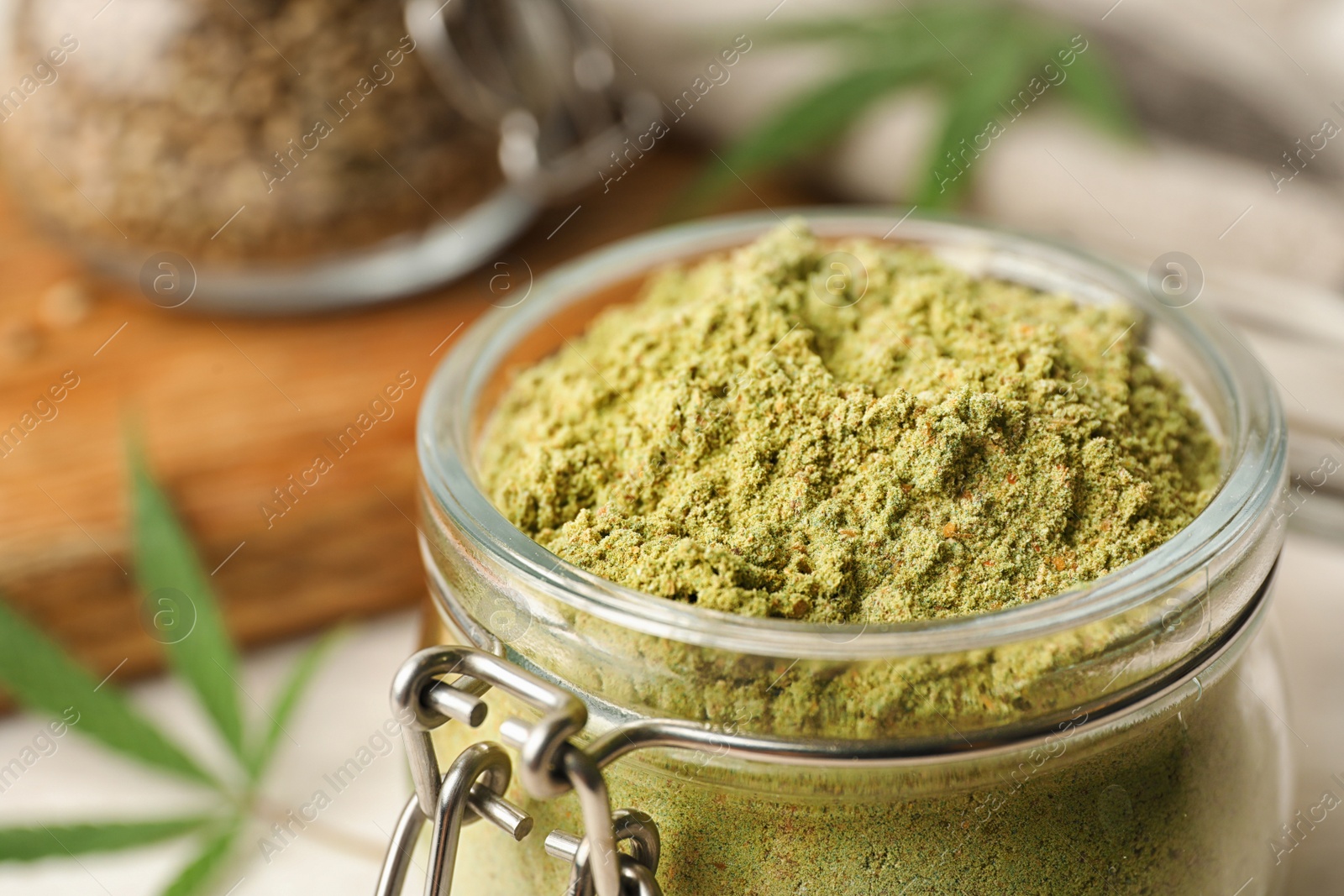 Photo of Jar of hemp protein powder on table, closeup