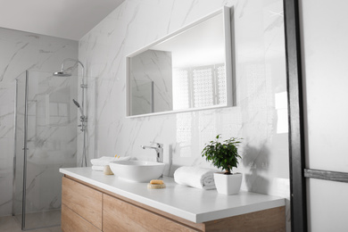 Photo of Modern mirror and vessel sink in stylish bathroom