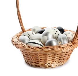 Photo of Basket with painted Easter eggs on white background, space for text