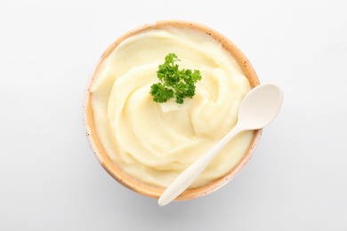 Photo of Bowl with tasty mashed potatoes on white background, top view