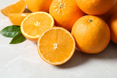 Photo of Pile of fresh ripe oranges on light background