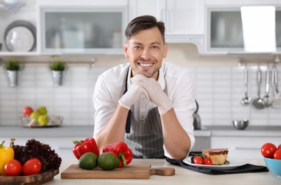 Photo of Professional chef in uniform at restaurant kitchen