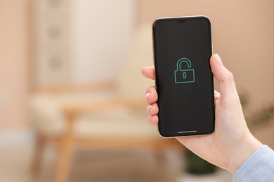Photo of Woman holding smartphone with blocked screen indoors, closeup. Space for text