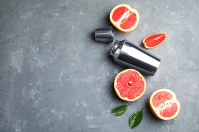 Photo of Flat lay composition with grapefruits and space for text on grey background