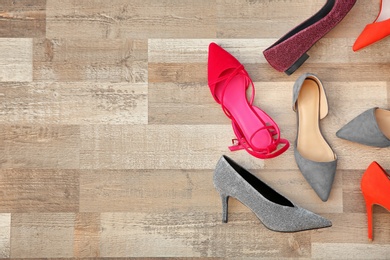 Photo of Different female shoes on floor, top view