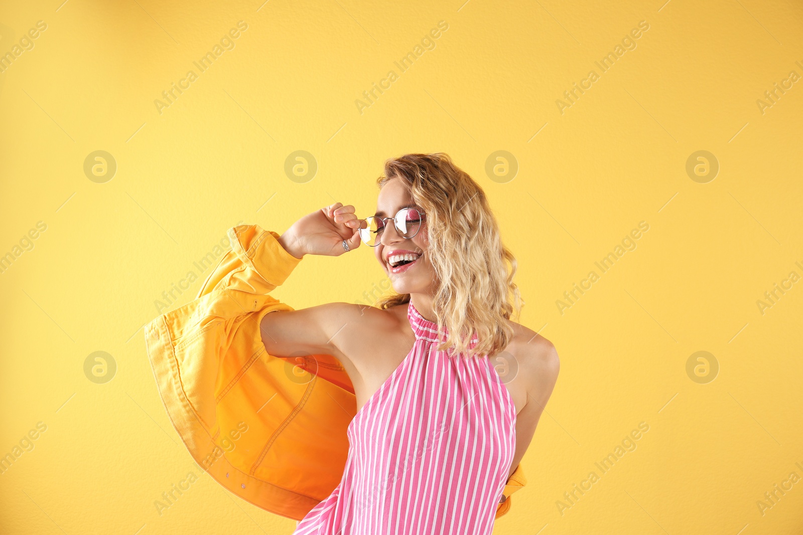 Photo of Beautiful young woman posing on color background. Summer fashion