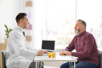 Photo of Male doctor consulting patient in clinic