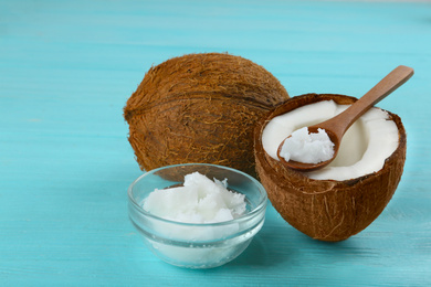 Photo of Composition with organic coconut oil on light blue wooden table. Healthy cooking