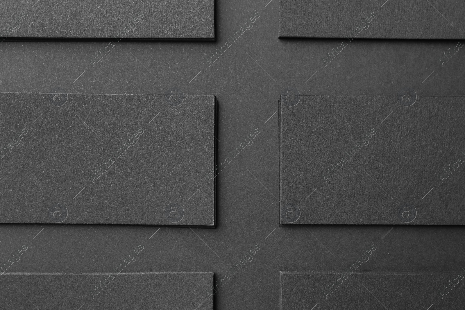 Photo of Blank business cards on black background, flat lay. Mockup for design