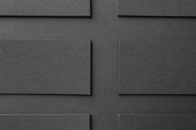 Photo of Blank business cards on black background, flat lay. Mockup for design