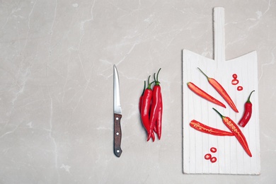 Photo of Flat lay composition with chili peppers on light background