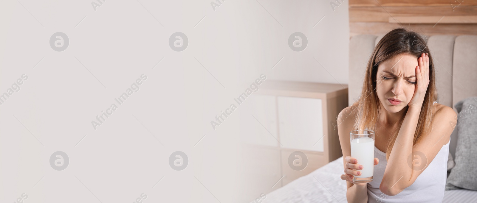 Image of Woman holding glass of medicine for hangover at home, space for text. Banner design