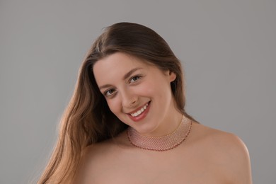 Photo of Portrait of beautiful young woman on grey background