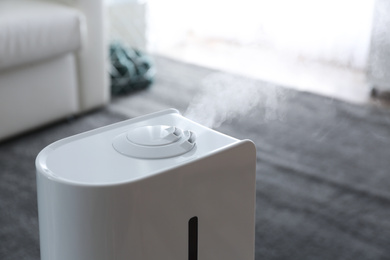 Photo of Modern air humidifier at home, closeup view