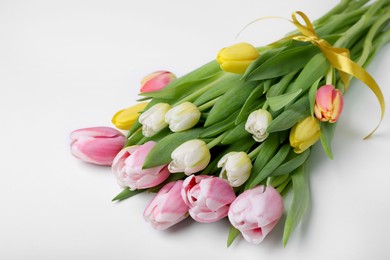 Photo of Bouquet of beautiful tulips on light background, closeup