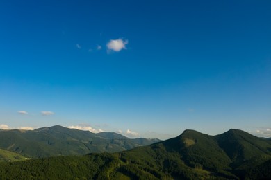 Image of Aerial view of beautiful mountain landscape with forest on sunny day. Drone photography