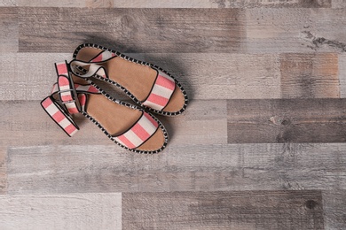 Photo of Pair of female shoes on wooden background, top view