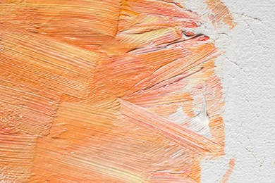 Beautiful strokes of colorful oil paints on white canvas, closeup