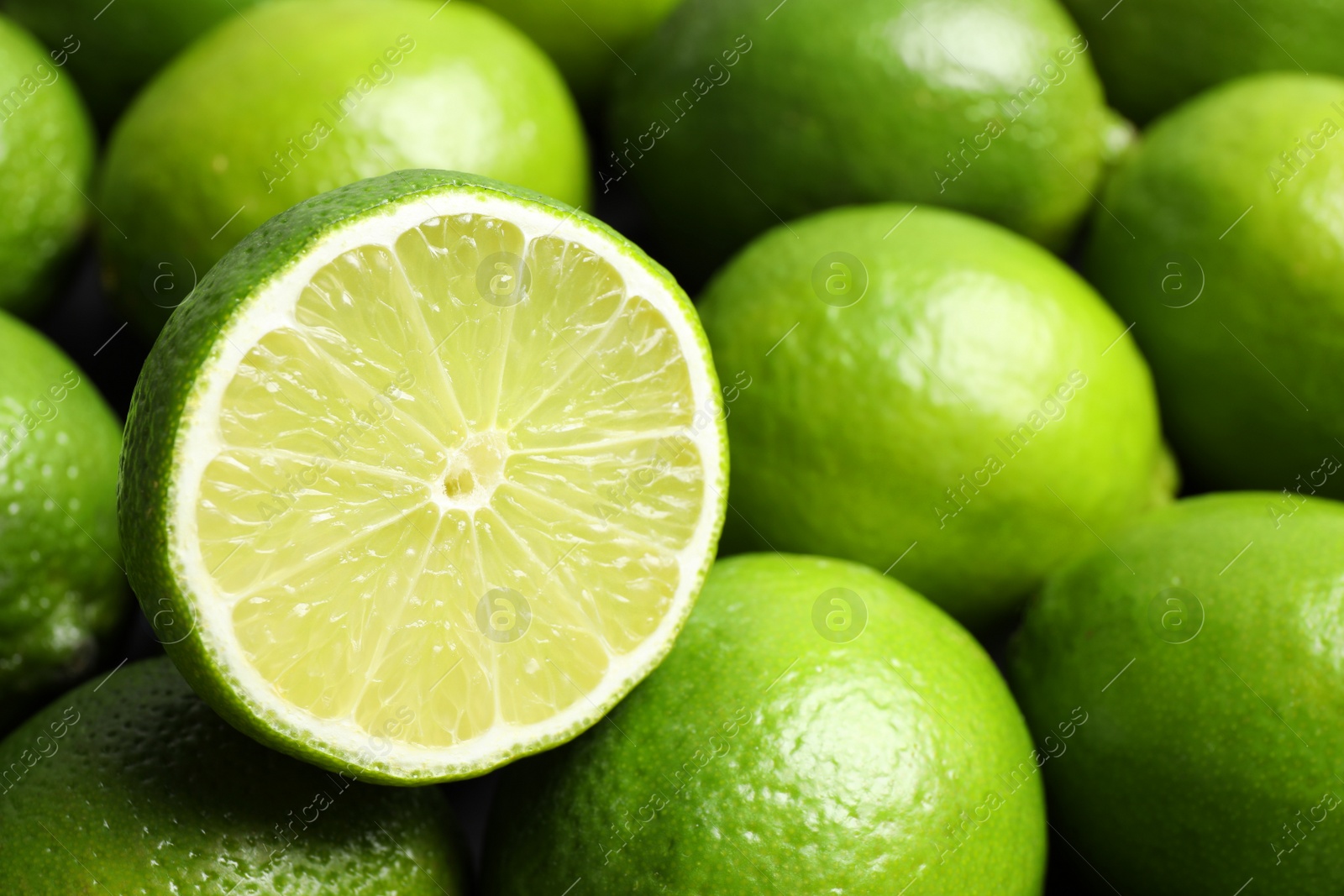 Photo of Fresh ripe juicy limes as background, closeup