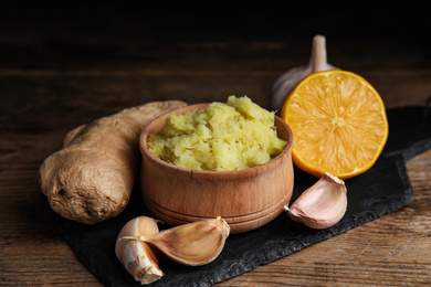 Photo of Fresh garlic and other natural cold remedies on wooden table