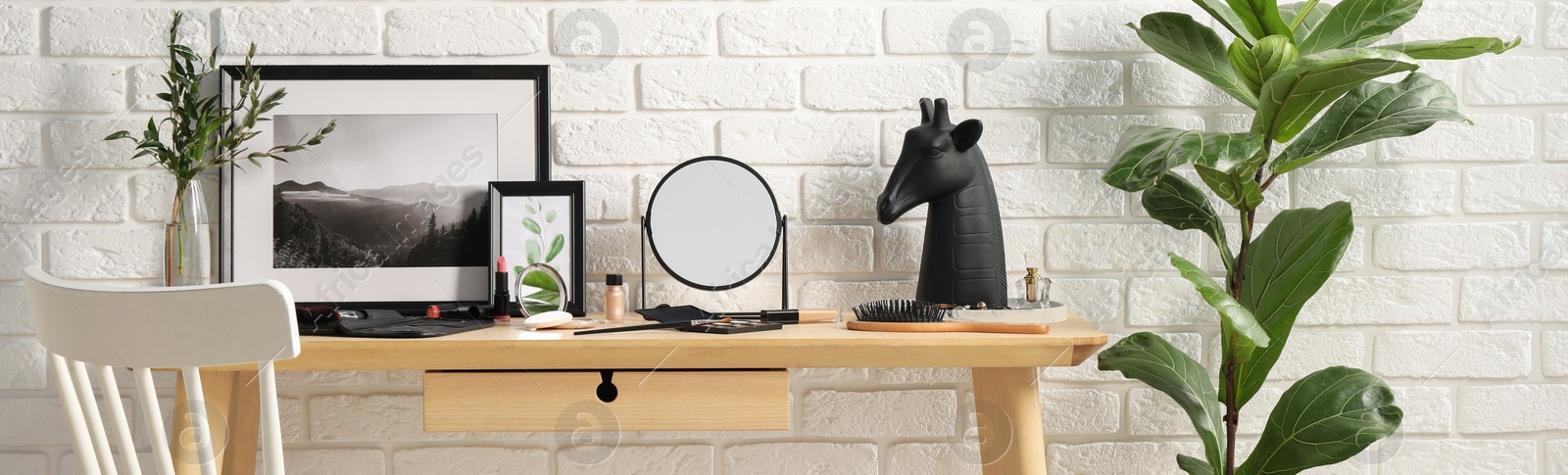 Image of Makeup room. Mirror, cosmetic products and accessories on wooden dressing table indoors, banner design