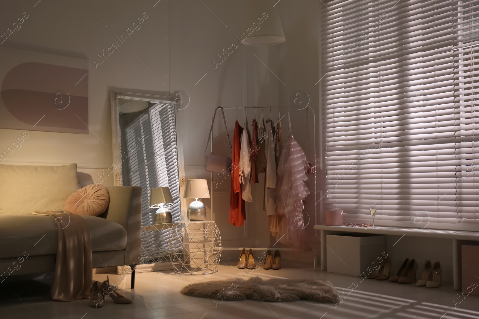 Photo of Modern dressing room interior with clothing rack and mirror