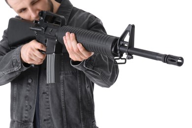 Photo of Assault gun. Man aiming rifle against white background, focus on barrel