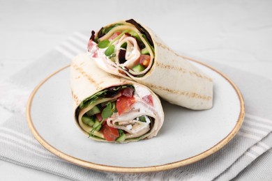 Delicious sandwich wraps with fresh vegetables on table, closeup