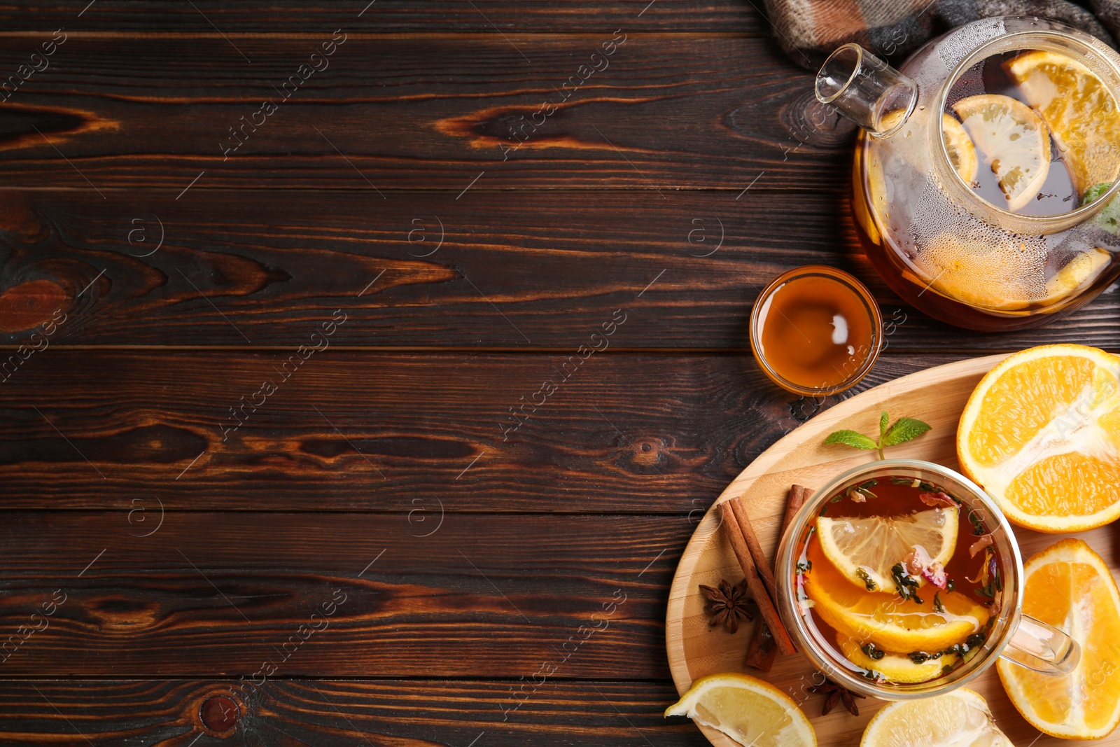 Photo of Flat lay composition with hot tea on wooden table. Space for text