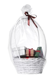 Photo of Wicker basket full of gift boxes on white background