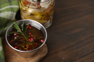 Photo of Tasty fish marinade with rosemary in bowl on wooden table, closeup. Space for text