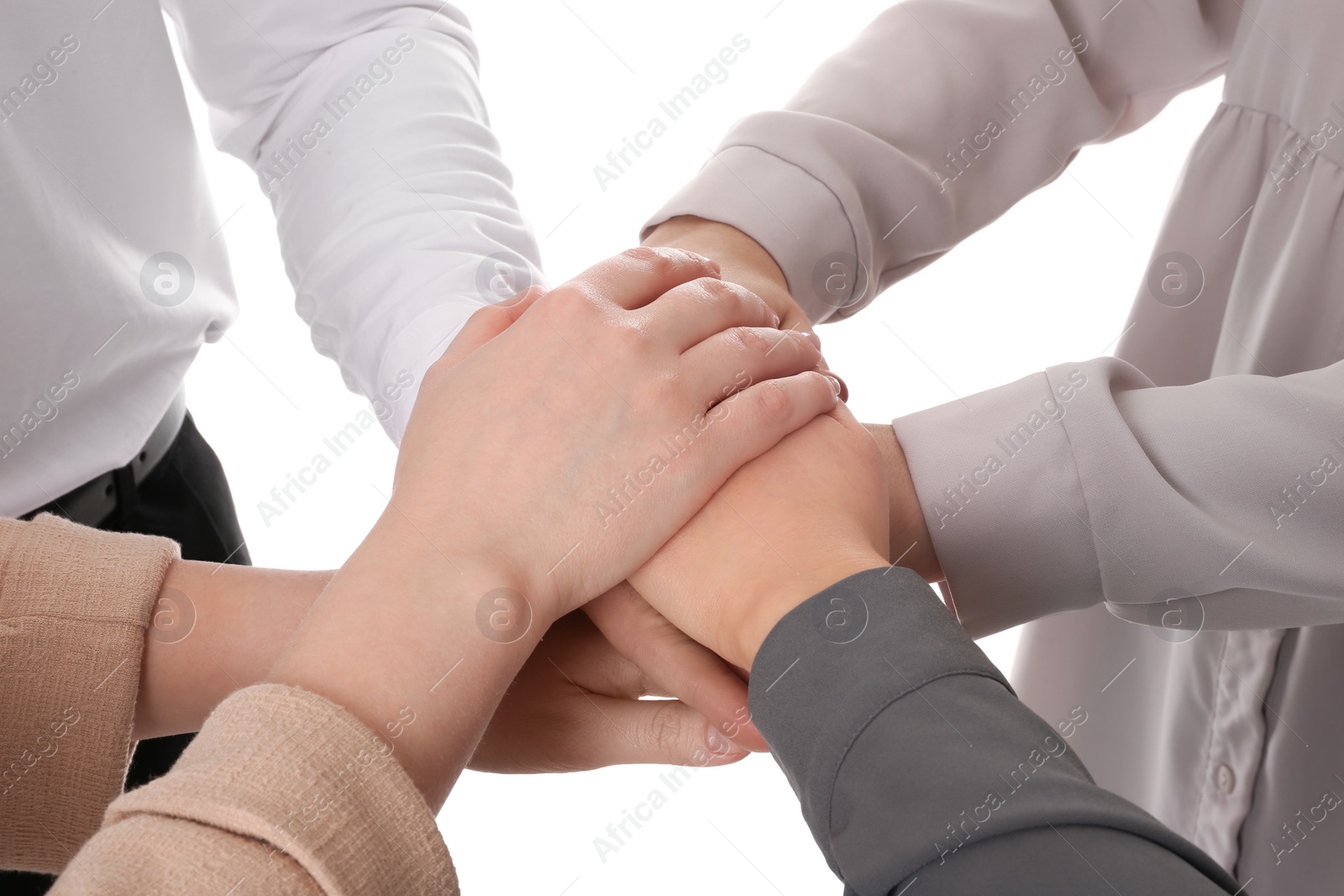 Photo of Group of people holding their hands together on white background, closeup