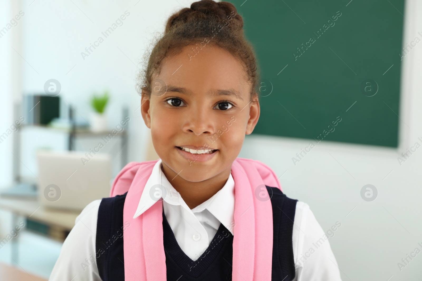 Photo of Portrait of African-American girl wearing school uniform in classroom