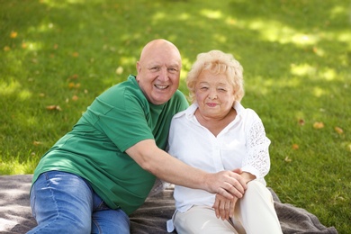 Photo of Happy elderly couple in park on sunny day