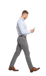 Man with smartphone walking on white background