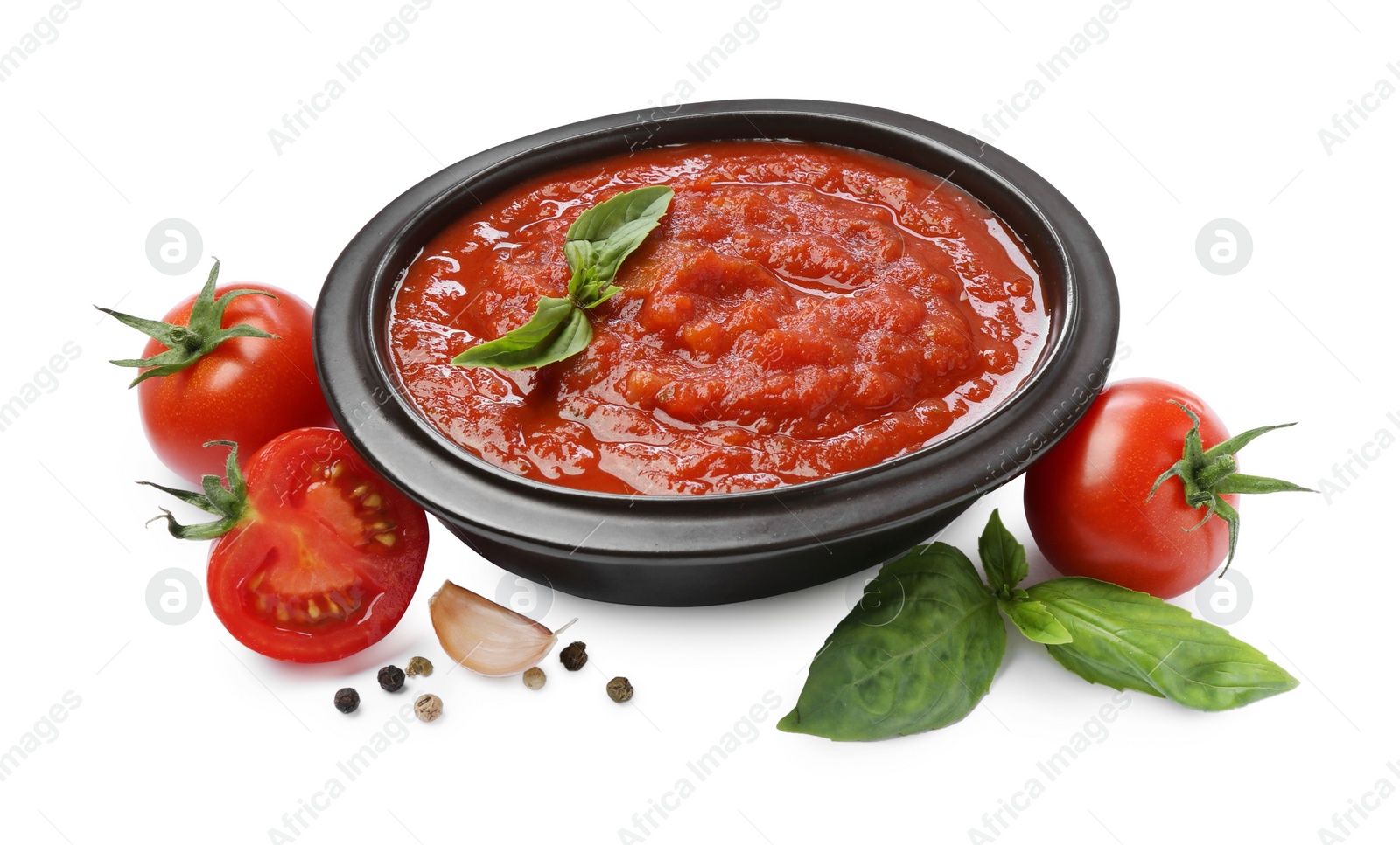 Photo of Homemade tomato sauce in bowl and fresh ingredients isolated on white