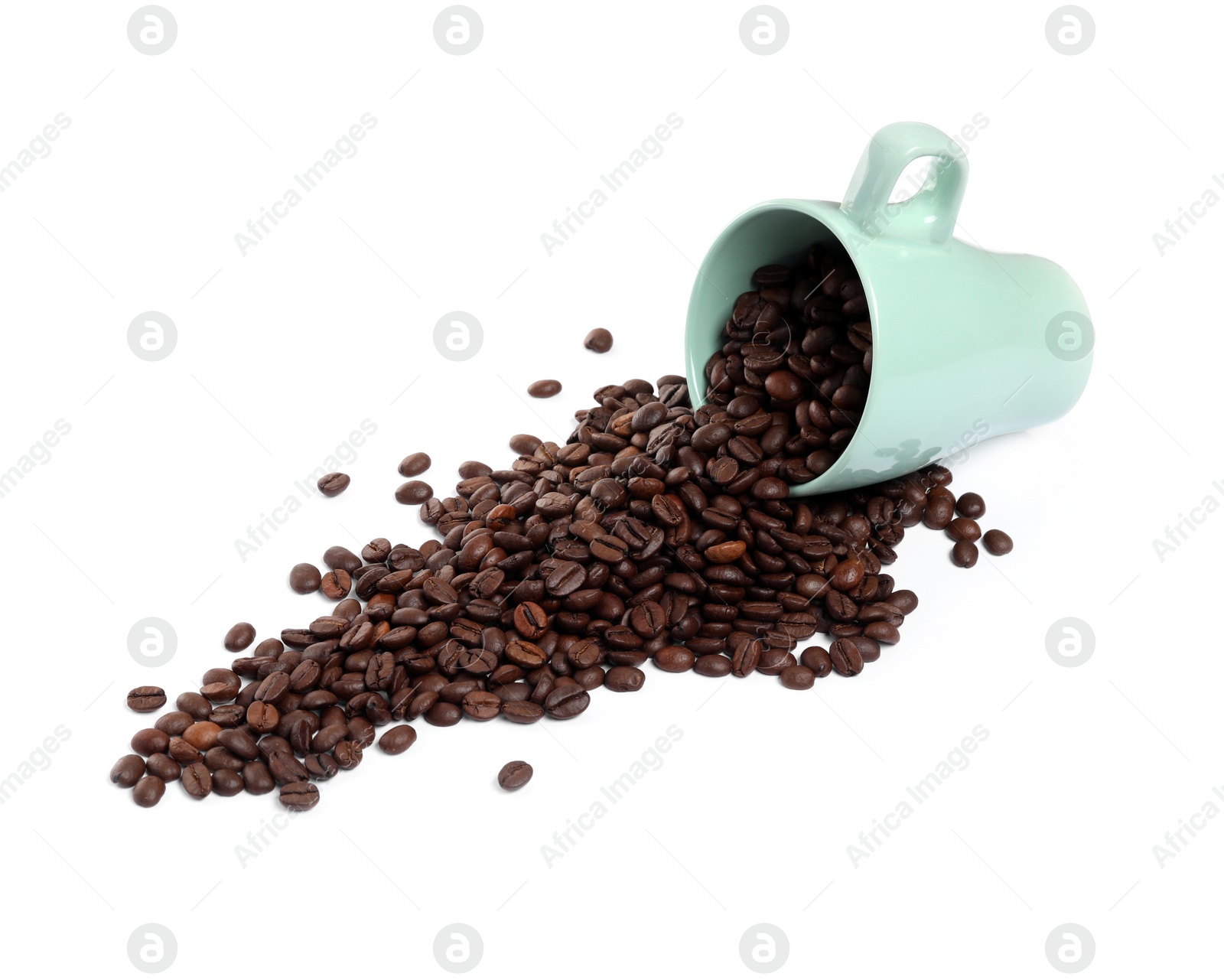 Photo of Coffee beans and overturned cup isolated on white