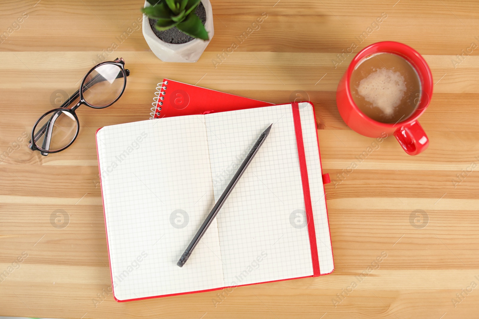 Photo of Flat lay composition with cup of coffee, plant and notebooks on wooden background